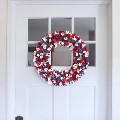 National Tree Company 21 in. Patriotic Wreath with Red White and Blue Flowers Petals Tinsel