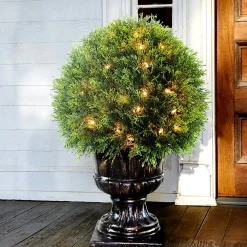 National Tree Company 27 in. Pre-Lit Upright Juniper Ball Topiary Tree in a Decorative Urn with Clear Lights