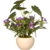 National Tree Company 18 in. Spring Purple Flower Blooms Potted Plant in a Cream Ceramic Pot